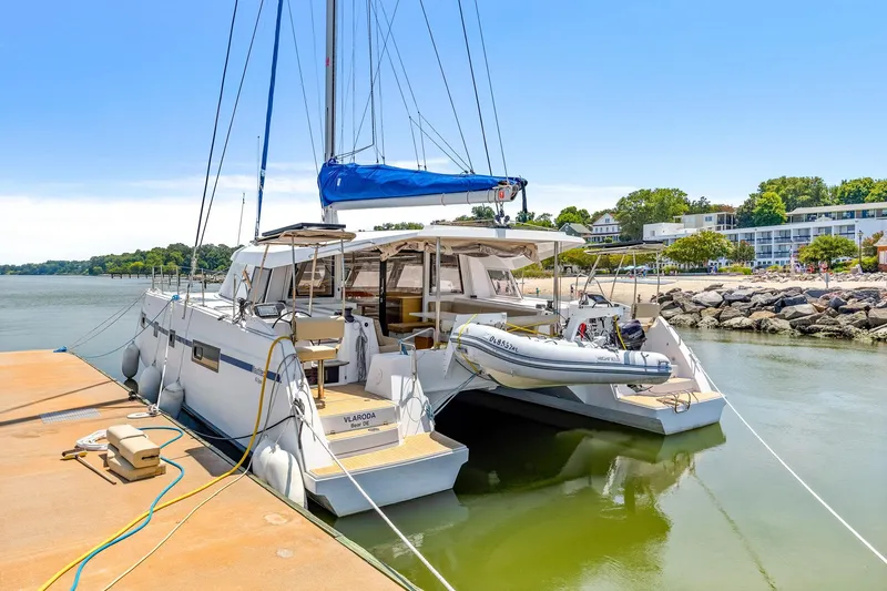 Slide: The Image of 2017 Nautitech 46 Open catamaran docked by a scenic shoreline. - 28