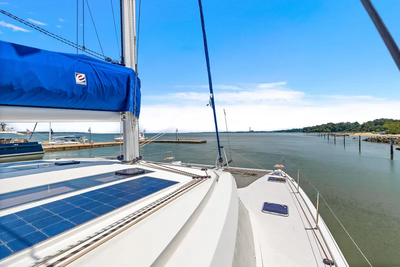 Slide: The Image of Nautitech 46 Open 2017 catamaran sailing on a calm river under a clear blue sky. - 36