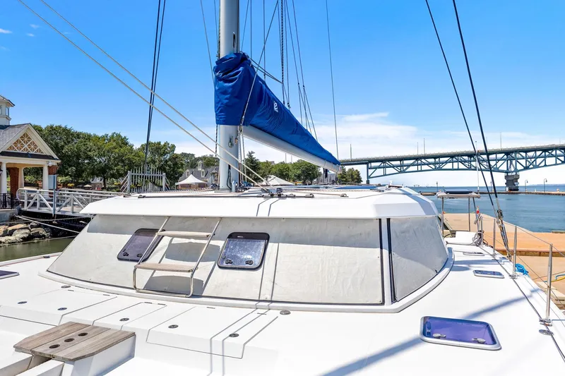 Slide: The Image of 2017 Nautitech 46 Open catamaran docked near a bridge, clear sky background. - 43