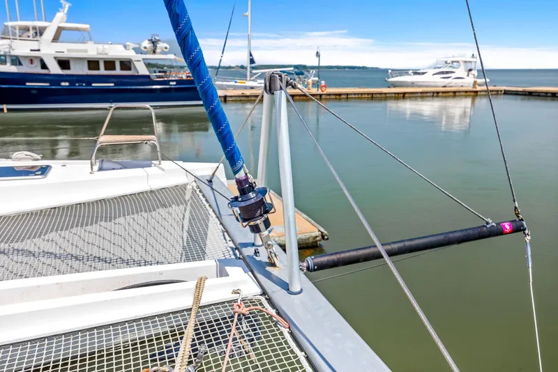 Slide: The Image of 2017 Nautitech 46 Open catamaran docked at marina, featuring deck and rigging details. - 46