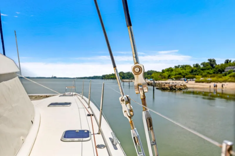 Slide: The Image of Nautitech 46 Open 2017 catamaran sailing near a scenic shoreline under a clear blue sky. - 48