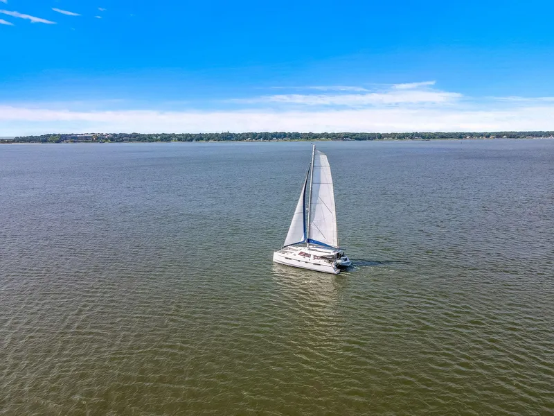 Slide: The Image of Sailing catamaran Nautitech 46 Open, 2017 model, on open water under clear blue sky. - 8