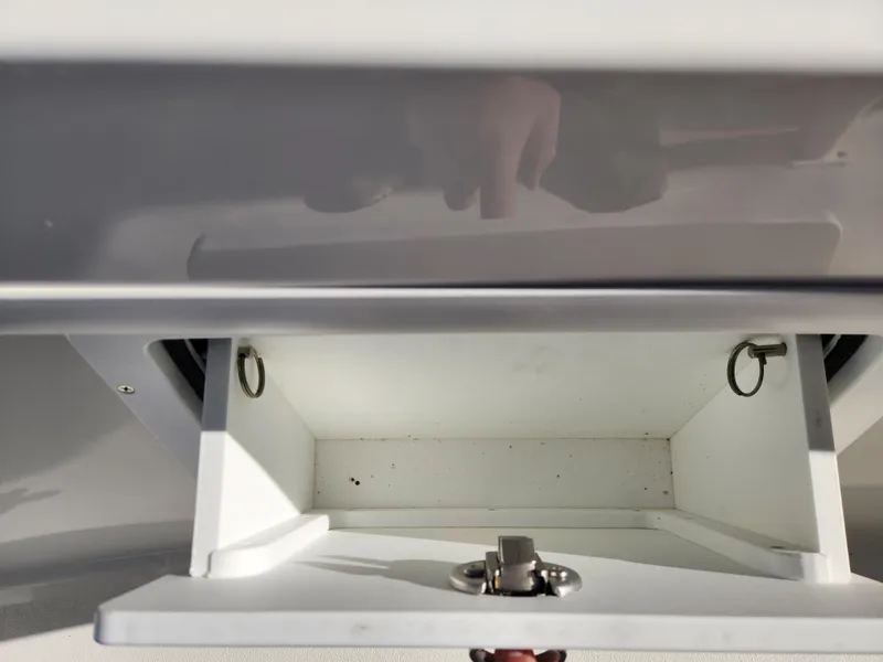 Slide: The Image of 2024 Pair Customs 27 CC boat interior with dual engines and cushioned seating. - 18