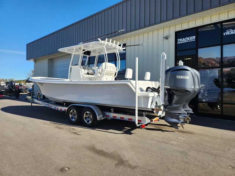 Slide: The Image of 2024 Pair Customs 27 CC boat on trailer with Yamaha engine, parked outdoors. - 2