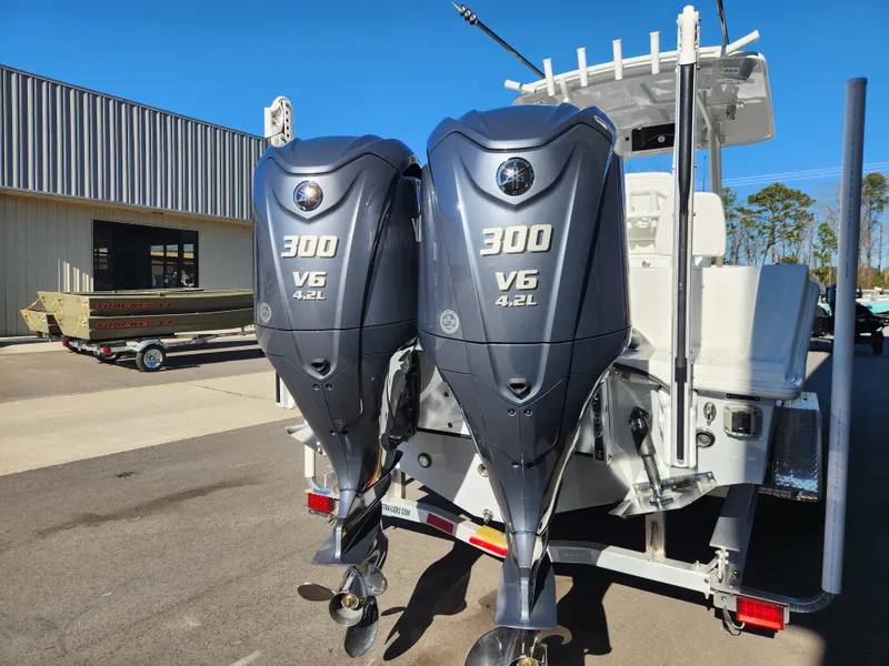 Slide: The Image of 2024 Pair Customs 27 CC boat on trailer with Yamaha engine, parked outdoors. - 6