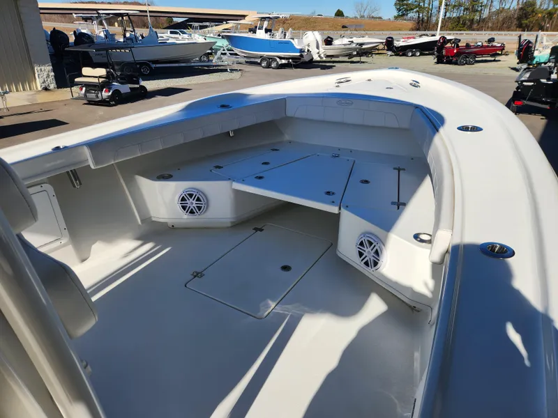 Slide: The Image of 2024 Pair Customs 27 CC boat console with Garmin navigation systems and steering wheel. - 10