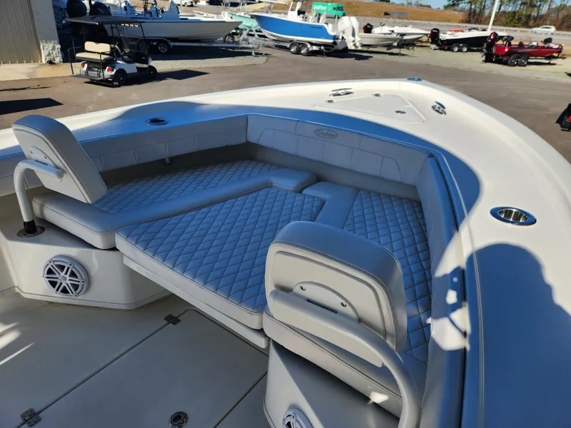 Slide: The Image of 2024 Pair Customs 27 CC boat interior with cushioned seating and storage compartments. - 13