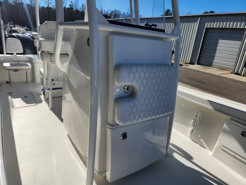 Slide: The Image of 2024 Pair Customs 27 CC boat side view with logo, parked on a trailer. - 19