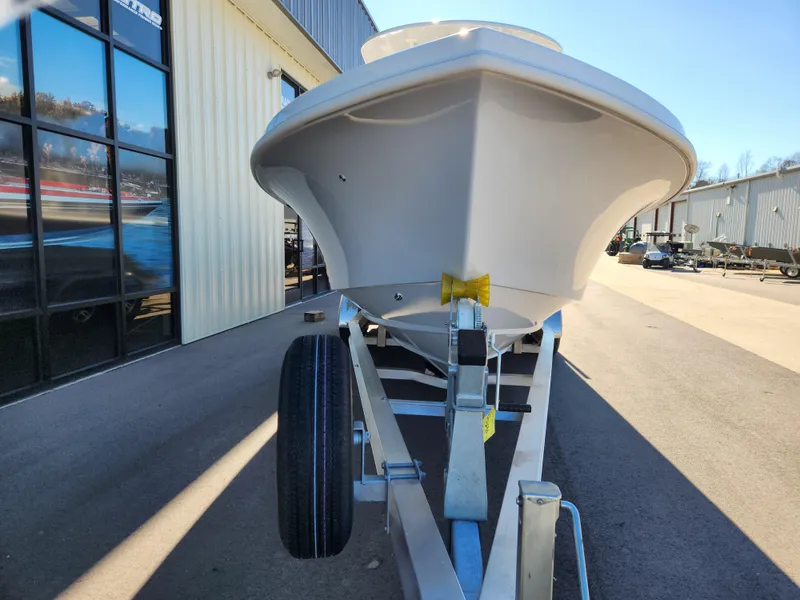 Slide: The Image of 2024 Pair Customs 27 CC boat on trailer, side view, outdoors. - 7