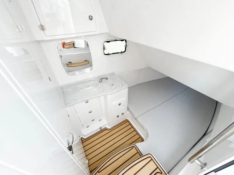 Slide: The Image of 2025 HCB 39 Speciale boat interior with sink, storage, and cushioned seating. - 4
