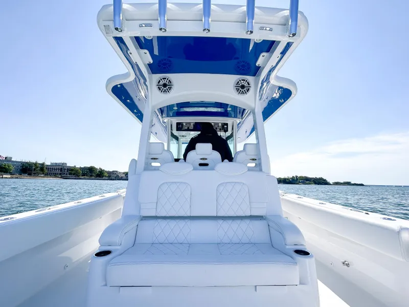 Slide: The Image of 2025 HCB 39 Speciale boat interior with white seating and blue accents on the water. - 6