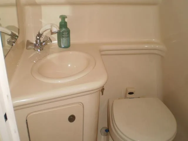 Slide: The Image of 2005 Sea Ray 260 Sundancer bathroom with sink and toilet. - 11