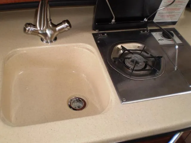 Slide: The Image of 2005 Sea Ray 260 Sundancer galley with sink and stove - 14