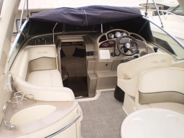 Slide: The Image of 2005 Sea Ray 260 Sundancer boat interior with helm, seating, and sink. - 3