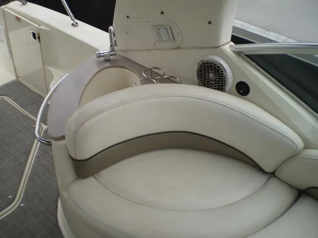 Slide: The Image of 2005 Sea Ray 260 Sundancer boat interior with cushioned seating and cup holders. - 6