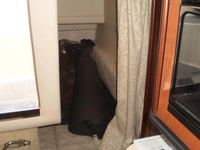 Slide: The Image of Interior cabin of a 2005 Sea Ray 260 Sundancer boat with rolled-up mat. - 9