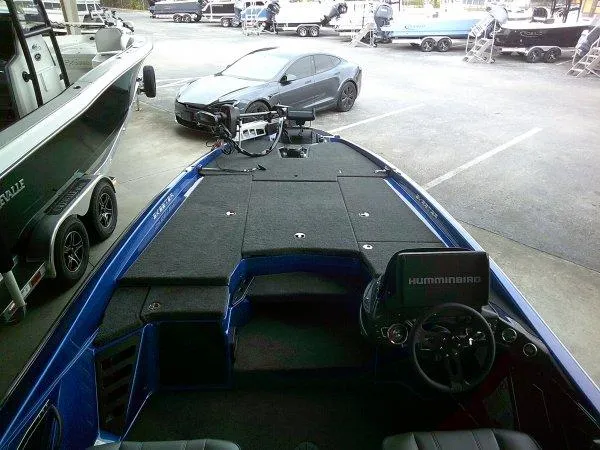 Slide: The Image of 2024 Skeeter ZXR20 bass boat with Humminbird electronics in a showroom. - 5