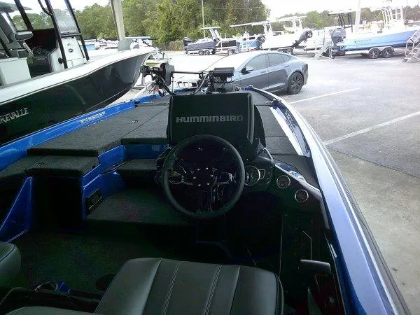 Slide: The Image of 2024 Skeeter ZXR20 boat interior with Humminbird electronics at a marina. - 9