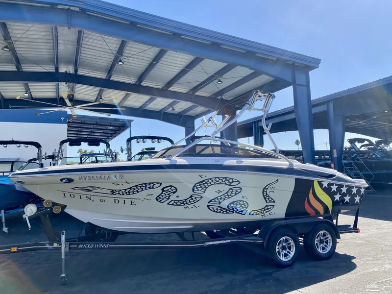 Slide: The Image of 2008 Four Winns Horizon 220SS boat with custom "Join, or Die" design in a marina. - 0