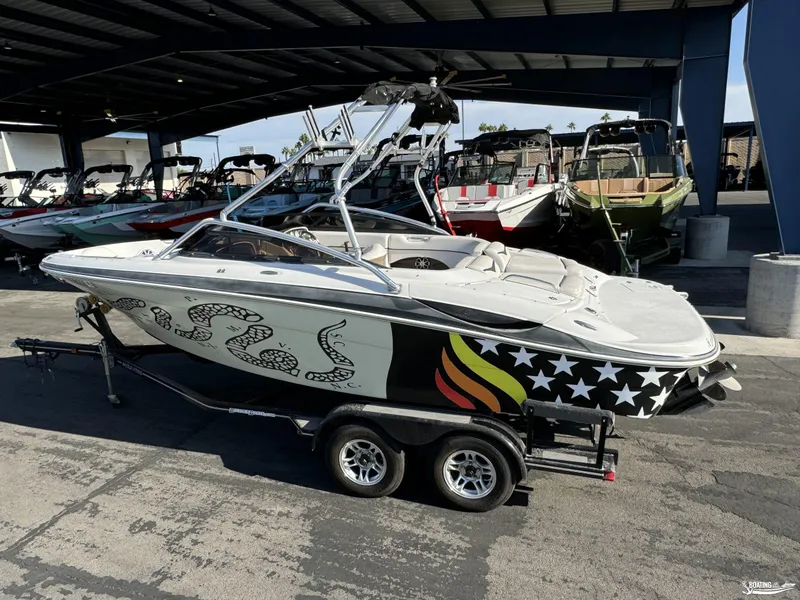 Slide: The Image of 2008 Four Winns Horizon 220SS boat with custom graphics on a trailer. - 1