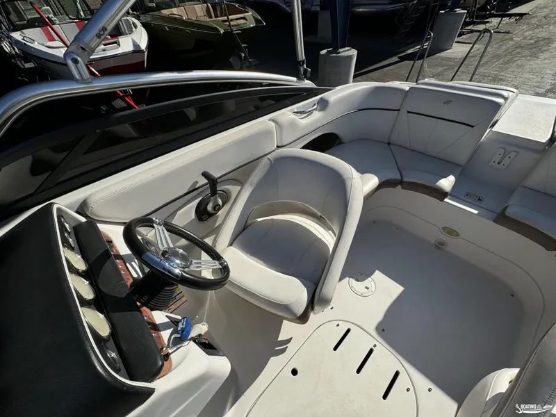 Slide: The Image of 2008 Four Winns Horizon 220SS boat interior with steering wheel and seating area. - 12