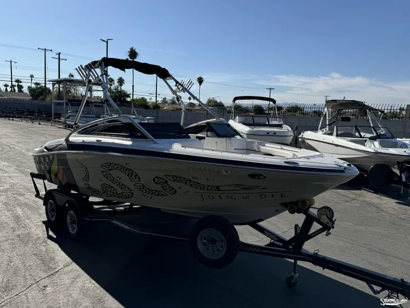 Slide: The Image of 2008 Four Winns Horizon 220SS boat on trailer in sunny marina. - 4