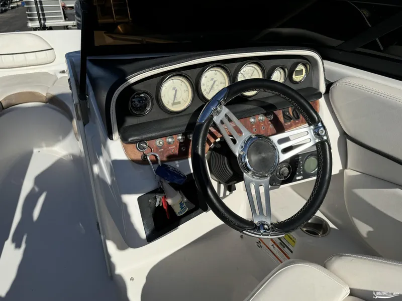 Slide: The Image of 2008 Four Winns Horizon 220SS boat dashboard with steering wheel and gauges. - 9