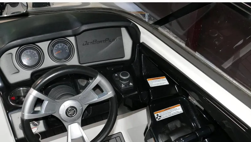 Slide: The Image of 2015 Yamaha AR240 boat dashboard with steering wheel and control panel. - 10