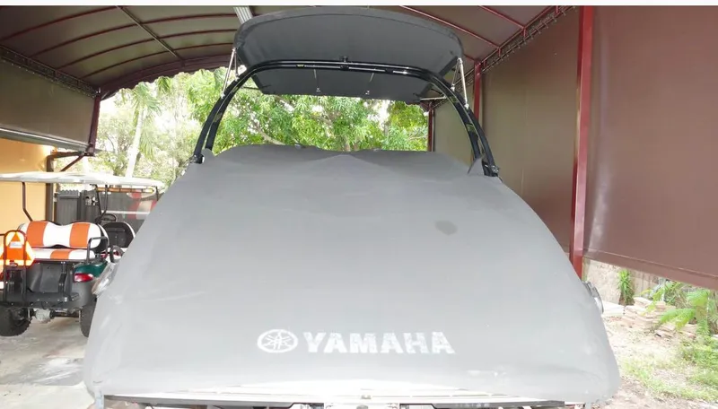 Slide: The Image of 2015 Yamaha AR240 boat covered in a garage with a golf cart nearby. - 20