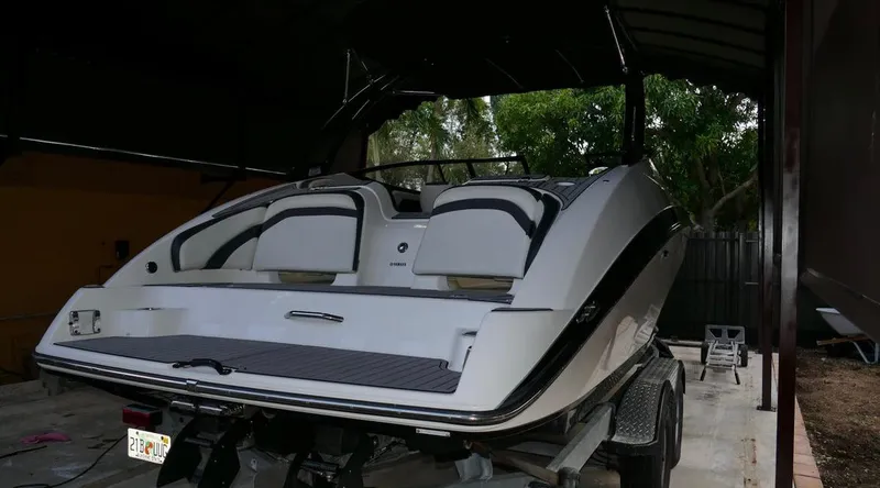Slide: The Image of 2015 Yamaha AR240 boat on trailer, parked under shelter. - 5