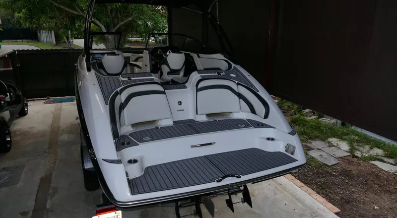 Slide: The Image of 2015 Yamaha Boats AR240 in a garage, showcasing sleek design and seating area. - 6