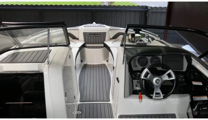Slide: The Image of 2015 Yamaha Boats AR240 interior with sleek dashboard and steering wheel. - 9