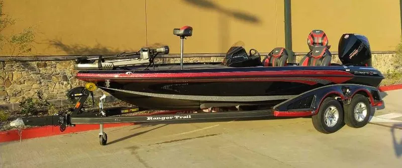 The Image of 2024 Ranger Z520R fishing boat on trailer, black and red design. - 0