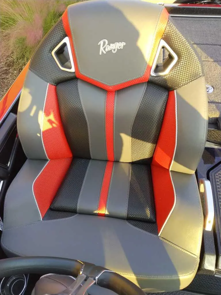 Slide: The Image of 2024 Ranger Z520R boat seat with red and gray accents. - 11