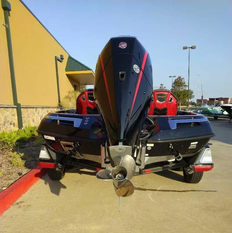 Slide: The Image of 2024 Ranger Z520R boat with powerful outboard motor, parked outdoors. - 3