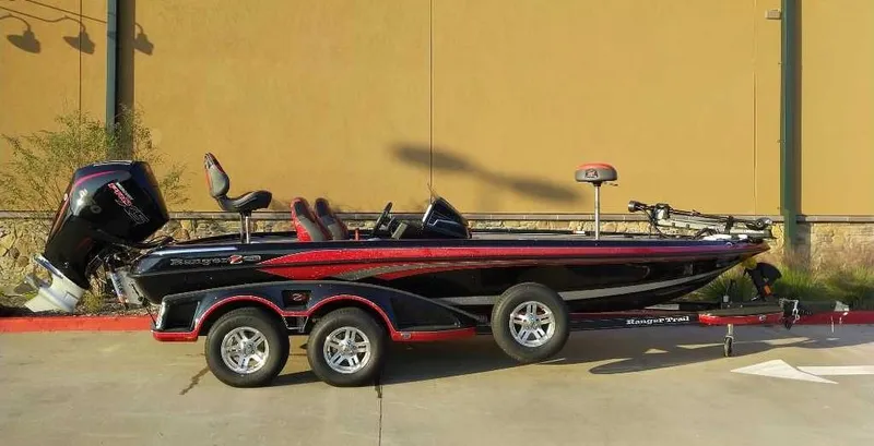 Slide: The Image of 2024 Ranger Z520R bass boat with dual axle trailer, parked outdoors. - 5