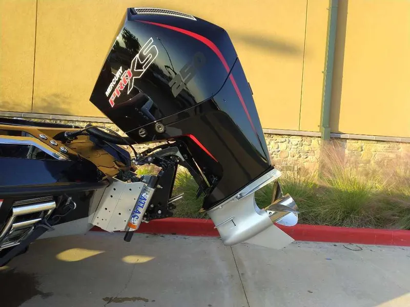 Slide: The Image of 2024 Ranger Z520R boat with powerful outboard motor in a parking area. - 6