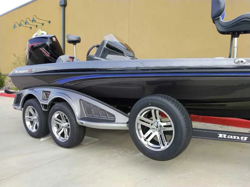 Slide: The Image of 2024 Ranger Z518 Ranger Cup Equipped boat with sleek design and triple-axle trailer. - 2