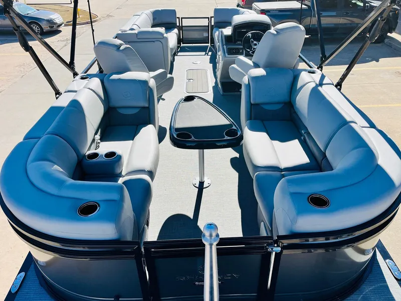 Slide: The Image of 2024 Regency 230 DL3 pontoon boat with spacious seating and modern design. - 10