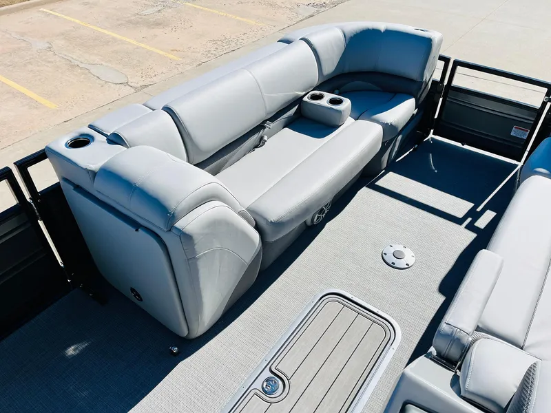 Slide: The Image of 2024 Regency 230 DL3 pontoon boat with luxurious seating and cup holders. - 12