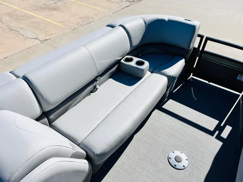 Slide: The Image of 2024 Regency 230 DL3 pontoon boat with gray seating and cup holders. - 14