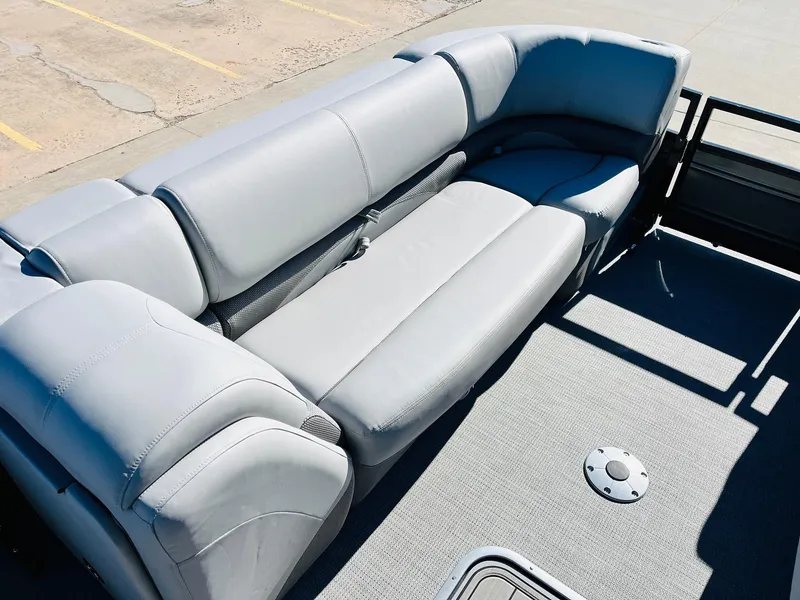Slide: The Image of 2024 Regency 230 DL3 pontoon boat with spacious gray seating. - 16