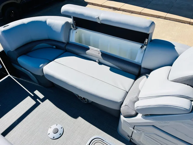 Slide: The Image of 2024 Regency 230 DL3 boat interior with gray cushioned seating and storage compartment. - 21