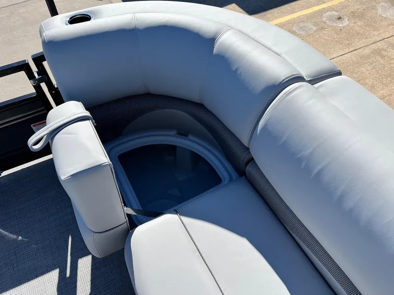 Slide: The Image of 2024 Regency 230 DL3 boat with gray cushioned seating and storage compartment. - 24