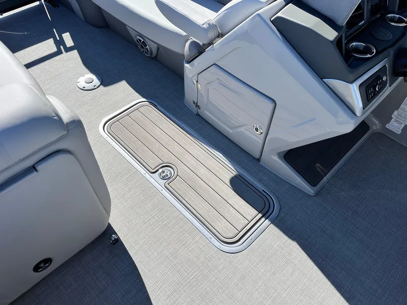 Slide: The Image of 2024 Regency 230 DL3 boat interior with storage compartment and seating. - 26