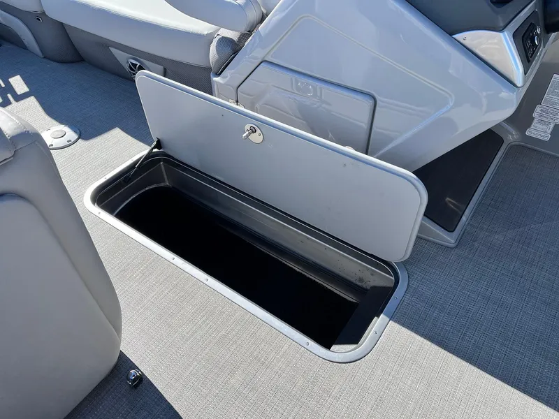 Slide: The Image of Open storage compartment on 2024 Regency 230 DL3 boat. - 27