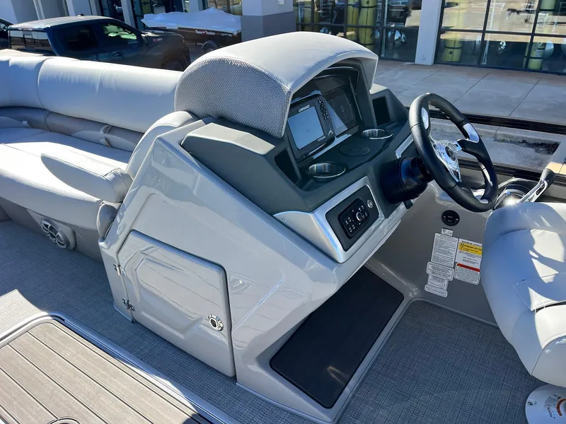Slide: The Image of 2024 Regency 230 DL3 boat dashboard with modern controls and comfortable seating. - 28