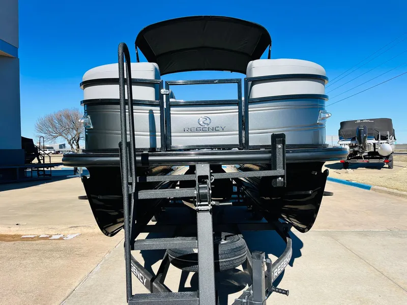 Slide: The Image of 2024 Regency 230 DL3 pontoon boat on a trailer, rear view. - 3