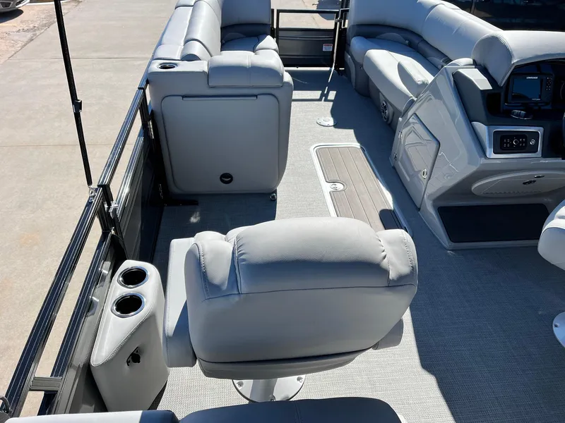 Slide: The Image of 2024 Regency 230 DL3 boat interior with plush seating and modern console. - 31