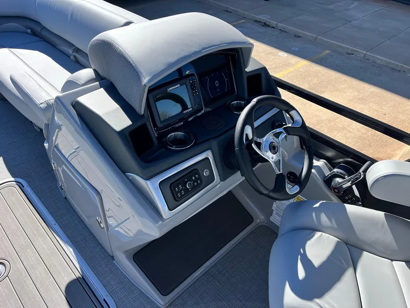 Slide: The Image of 2024 Regency 230 DL3 boat dashboard with steering wheel and control panel. - 32